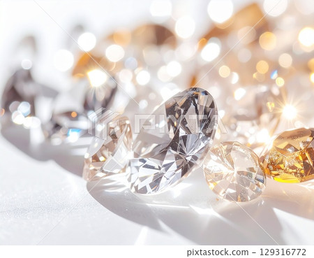 A close-up background image of a simple white background with jewels sparkling in the light A close-up background image of a simple white background with jewels sparkling in the light 129316772