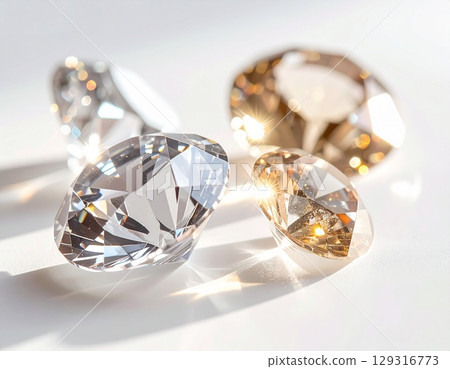 A close-up background image of a simple white background with jewels sparkling in the light 129316773