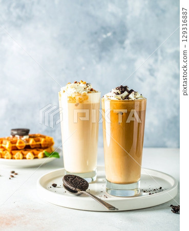 coffee moment, two iced lattes in tall ribbed glass coffee moment, two iced lattes in tall ribbed glass 129316887