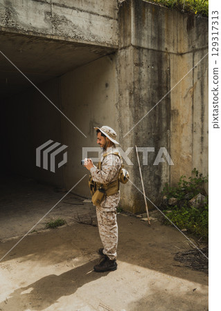 War Journalist In Uniform Looking At The Photos He Took War Journalist In Uniform Looking At The Photos He Took 129317313