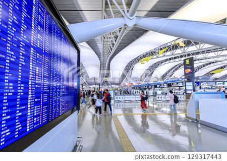 The international departure lobby at Kansai Airport is crowded with tourists. The international departure lobby at Kansai Airport is crowded with tourists. 129317443
