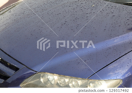 water droplets on car hood water droplets on car hood 129317492