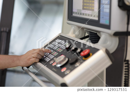 operator at the controls of metalworking machine operator at the controls of metalworking machine 129317531