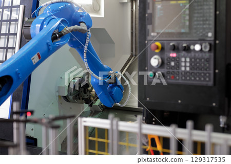 robot loading parts into CNC lathe machine robot loading parts into CNC lathe machine 129317535