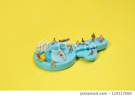 miniature bathers on a blue hand-powered fan miniature bathers on a blue hand-powered fan 129317660