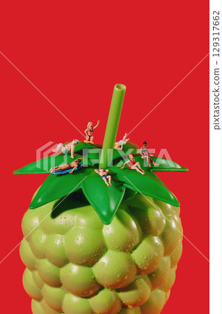 miniature people in swimwear on a green bottle miniature people in swimwear on a green bottle 129317662