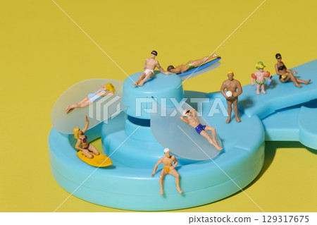 beachgoers on top of a hand-powered fan 129317675