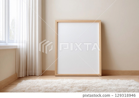 Empty picture frame for mockup placed on wooden floor next to bright window with curtains in modern room setting during daylight hours 129318946