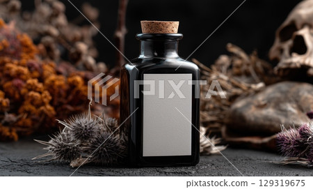 Mockup of black glass potion bottle with blank white label on Halloween theme background with copy space for text, dark color tone. Mockup of black glass potion bottle with blank white label on Halloween theme background with copy space for text, dark color tone. 129319675