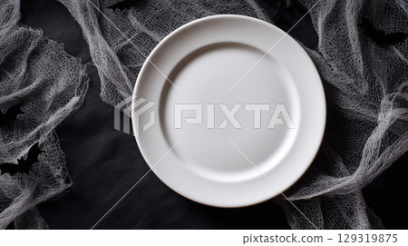 Mockup of plain white plate on Halloween theme background with copy space for text, Black and white color tone. 129319875