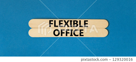 Flexible office symbol. Concept words Flexible office on beautiful wooden stick. Beautiful blue paper background. Business Flexible office concept. Copy space. 129320016