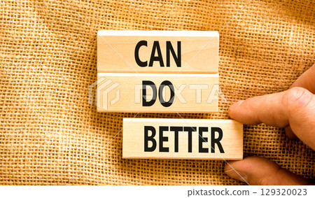 Can do better symbol. Concept words Can do better on beautiful wooden block. Businessman's hand. Beautiful canvas background. Business and can do better concept. Copy space. 129320023