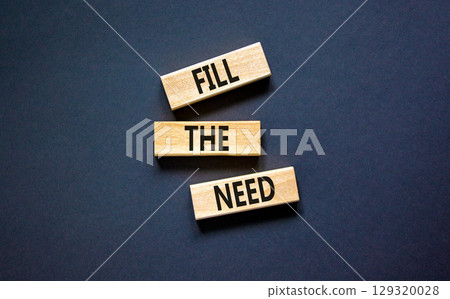 Fill the need symbol. Concept words Fill the need on wooden blocks on a beautiful black table black background. Business, finacial and fill the need concept. Copy space. 129320028