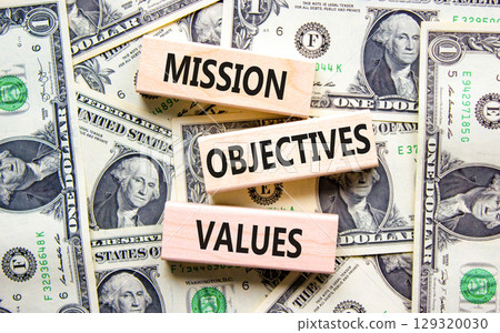 Mission objectives values symbol. Concept words Mission Objectives Values on beautiful blocks. Dollar bills. Beautiful dollar bills background. Business mission objectives values concept. Copy space. 129320030