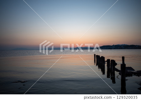 Sunset over a quiet lake Sunset over a quiet lake 129320035