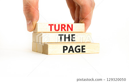 Turn the page symbol. Concept words Turn the page on beautiful wooden block. Businessman's hand. Beautiful white background. Business motivational lifestyle turn the page concept. Copy space. 129320050