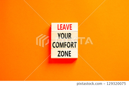 Leave your comfort zone symbol. Concept words Leave your comfort zone on beautiful wooden blocks. Beautiful orange paper background. Business psychological Leave your comfort zone concept. Copy space. 129320075