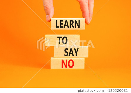 Learn to say no symbol. Concept words phrase Learn to say no on beautiful wooden blocks. Beautiful orange paper background. Businessman's hand Business psychological Learn to say no concept Copy space 129320081