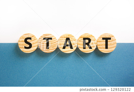 Start symbol. Concept word Start on beautiful wooden circles. Beautiful white and blue background. Business lifestyle start concept. Copy space. 129320122