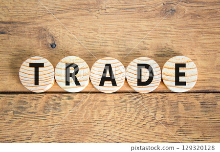 Trade symbol. Concept word Trade on beautiful wooden circles. Beautiful wooden table wooden background. Business lifestyle trade concept. Copy space. 129320128