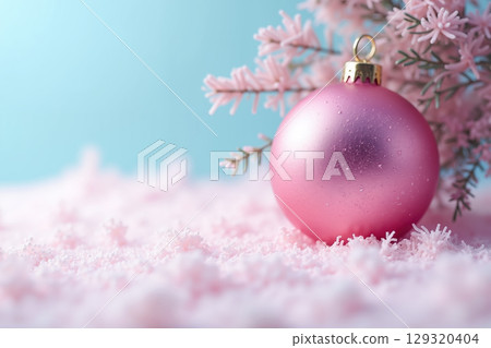 Pink Christmas ornament on snow. 129320404
