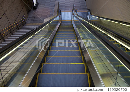 A long downward escalator in the city A long downward escalator in the city 129320700