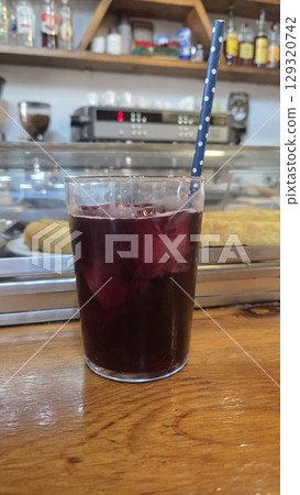 Refreshing tinto de verano beverage in a cozy cafe setting. Traditional spanish summer cocktail with wine and ice 129320742