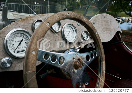 Vintage car with a wooden steering wheel and gauges 129320777