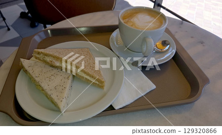 Hearty morning delight with sandwiches and coffee in a cozy cafe setting. Top view. Flat lay 129320866
