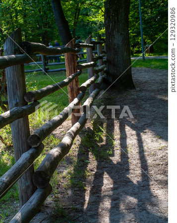 Wooden fence with a tree behind it Wooden fence with a tree behind it 129320986