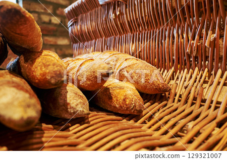 Basket of bread is displayed in a store 129321007