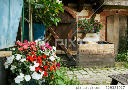 Wooden door with a flower box on the side Wooden door with a flower box on the side 129321027