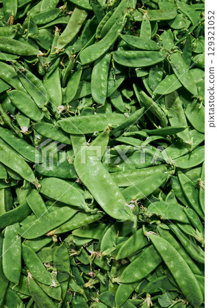 Bunch of green peas are piled on top of each other 129321052