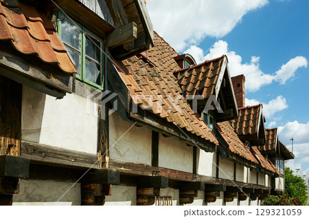 Row of old houses with red roofs and white walls 129321059