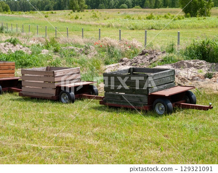 Two wooden crates are sitting in a field Two wooden crates are sitting in a field 129321091