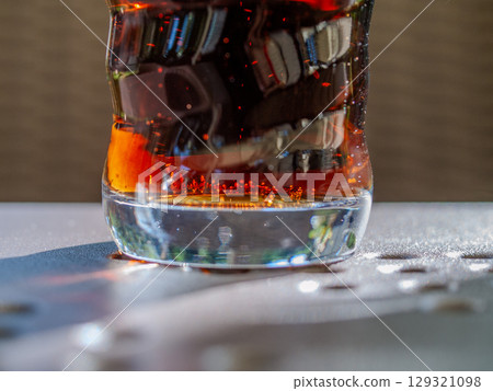Glass of soda with a swirl pattern on the side 129321098