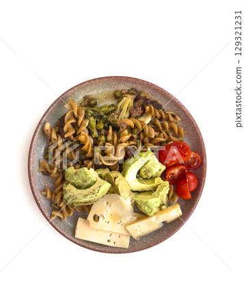Pasta with avocado, cheese and tomatoes on a white background 129321231