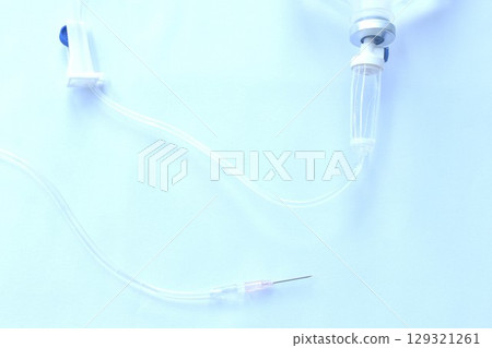 needle for saline solution and rubber tube arranging on white background 129321261