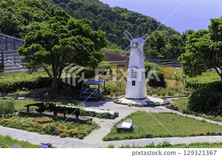 A view of the white windmill and lush garden from the observation terrace of the Sada Peninsula Museum 129321367