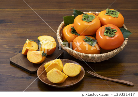 Persimmons in a colander 129321417