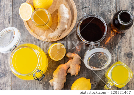 Colorful Kombucha Jars and Bottles on wooden table Colorful Kombucha Jars and Bottles on wooden table 129321467