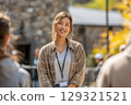 Smiling tour guide welcoming visitors to a historic site with a friendly gesture 129321521