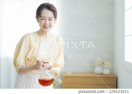 Middle-aged woman drinking tea Middle-aged woman drinking tea 129321611