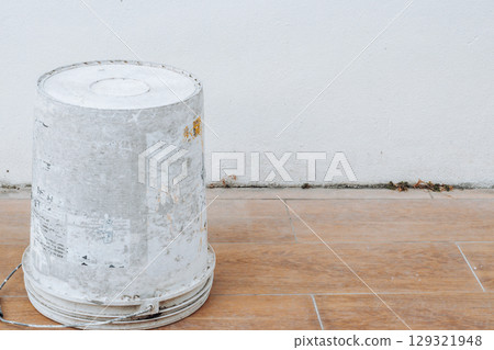 An overturned bucket rolling on the ground 129321948