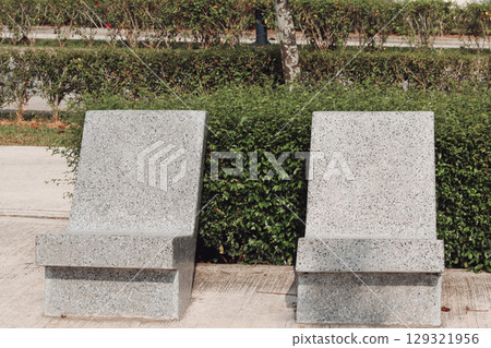 A bench in a park overseas and a landscape brimming with greenery A bench in a park overseas and a landscape brimming with greenery 129321956