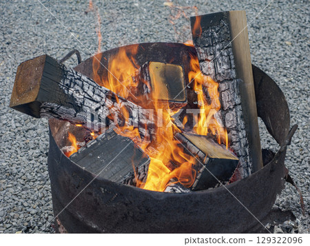 Burning flames and the warmth of a bonfire Burning flames and the warmth of a bonfire 129322096