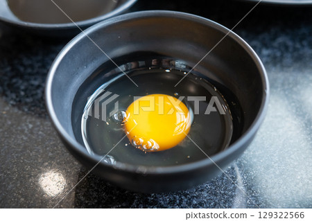 Raw egg in a bowl Raw egg in a bowl 129322566
