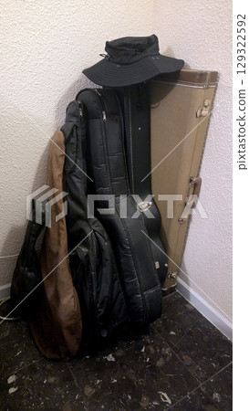 Collection of musical instrument cases in corner for storage or travel Collection of musical instrument cases in corner for storage or travel 129322592