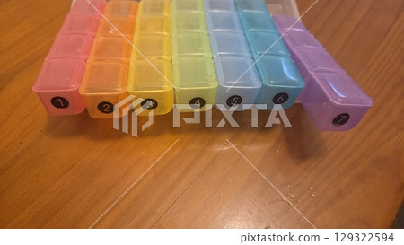 Weekly pill organizer with seven compartments for daily medication management. Pill boxes Weekly pill organizer with seven compartments for daily medication management. Pill boxes 129322594