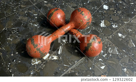 Vintage red dumbbells on stone floor for fitness and exercise concepts Vintage red dumbbells on stone floor for fitness and exercise concepts 129322602